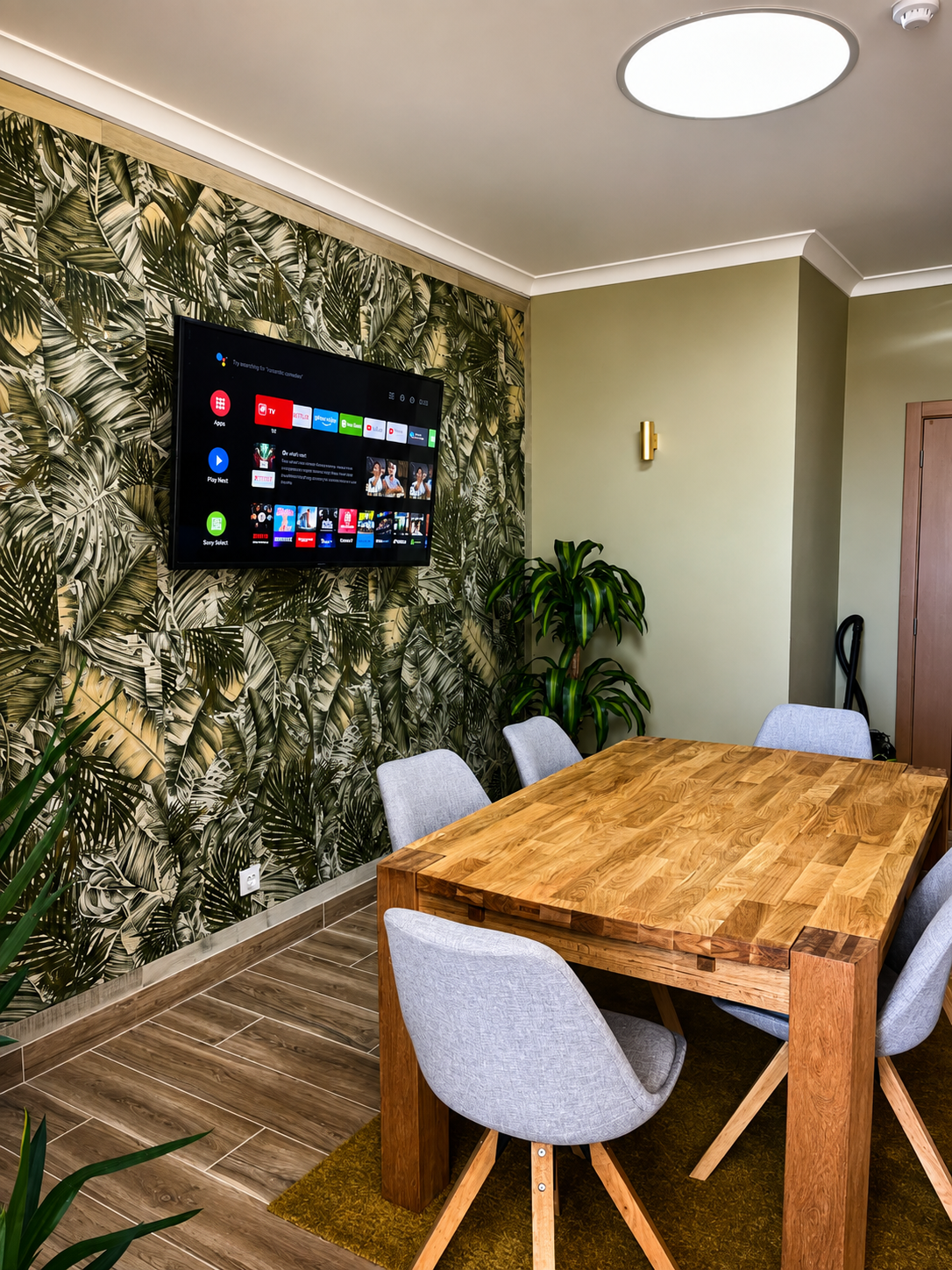 Meeting room with large presentation screen and palm-print wall