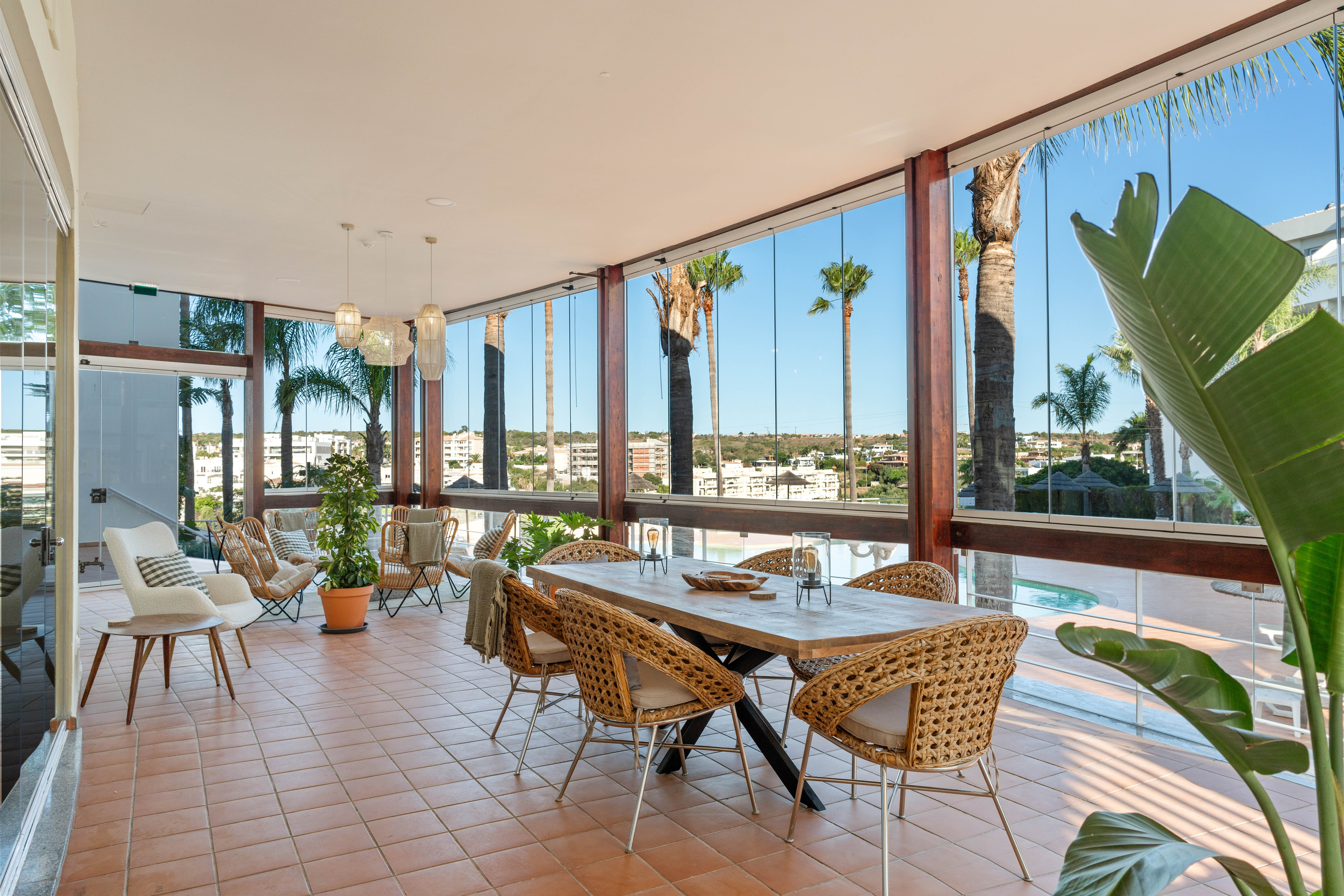 Glazed veranda with pool view for post-meeting lunches